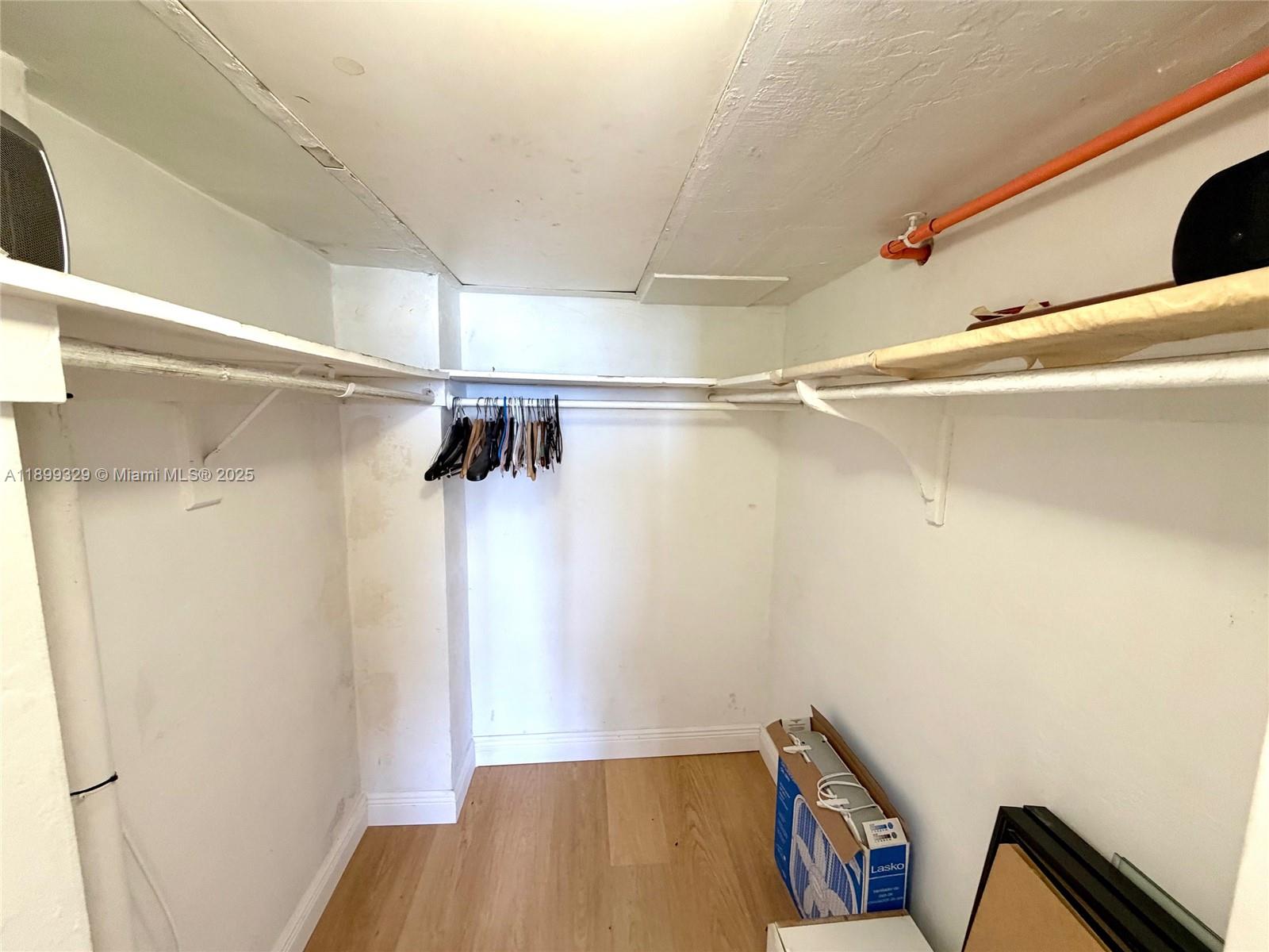 1500 Bay Road, Unit 1274S Miami Beach, FL 33139 - Photo 14 of 36 a view of walk in closet with clothes and shoes