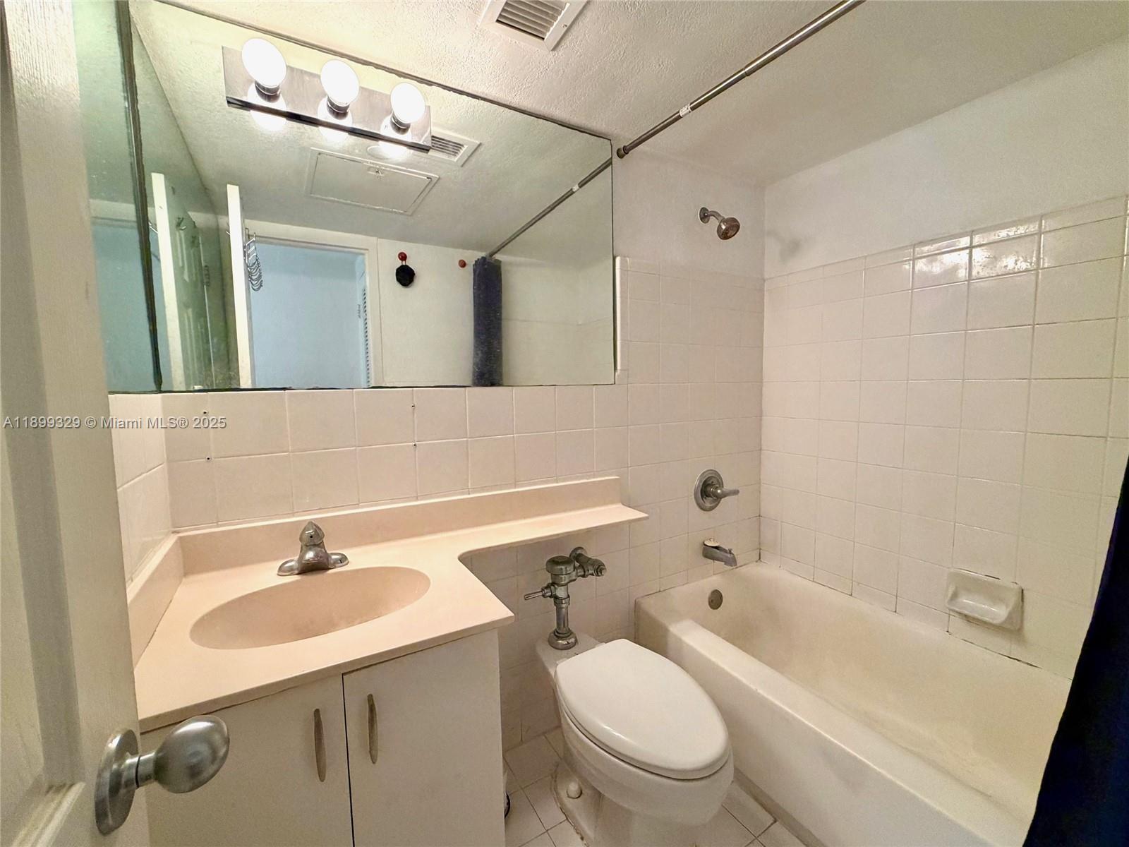 1500 Bay Road, Unit 1274S Miami Beach, FL 33139 - Photo 15 of 36 a bathroom with a sink a toilet and shower