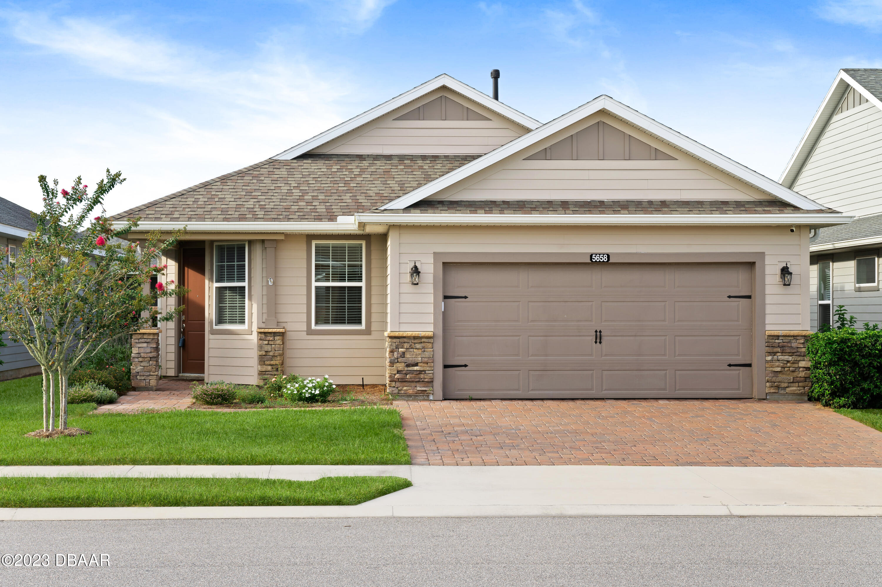 a front view of a house with a yard and garage