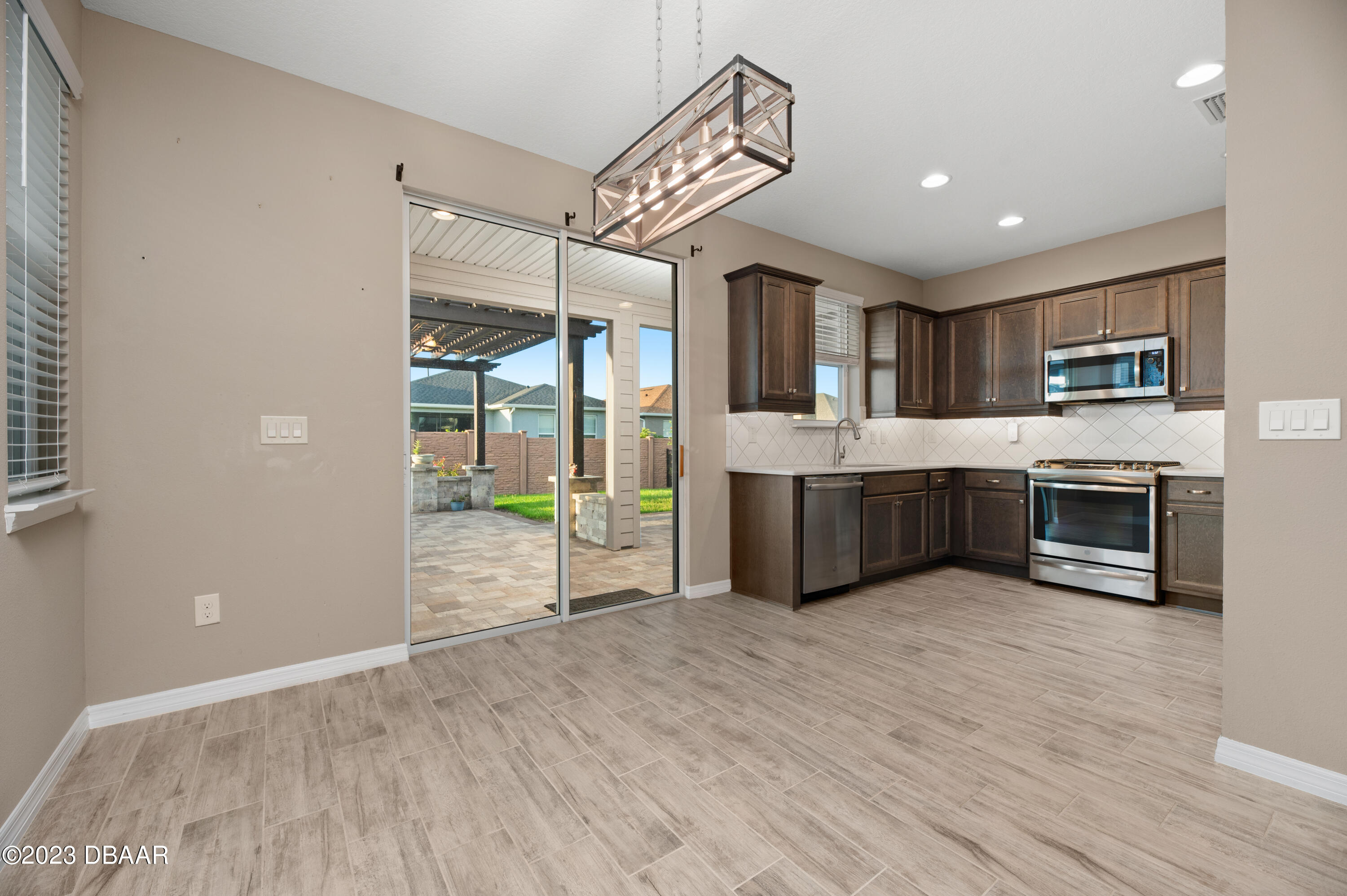 5658 Northwest 40th Loop Ocala, FL 34482 - Photo 12 of 80 a large kitchen with stainless steel appliances granite countertop a stove and a wooden floors