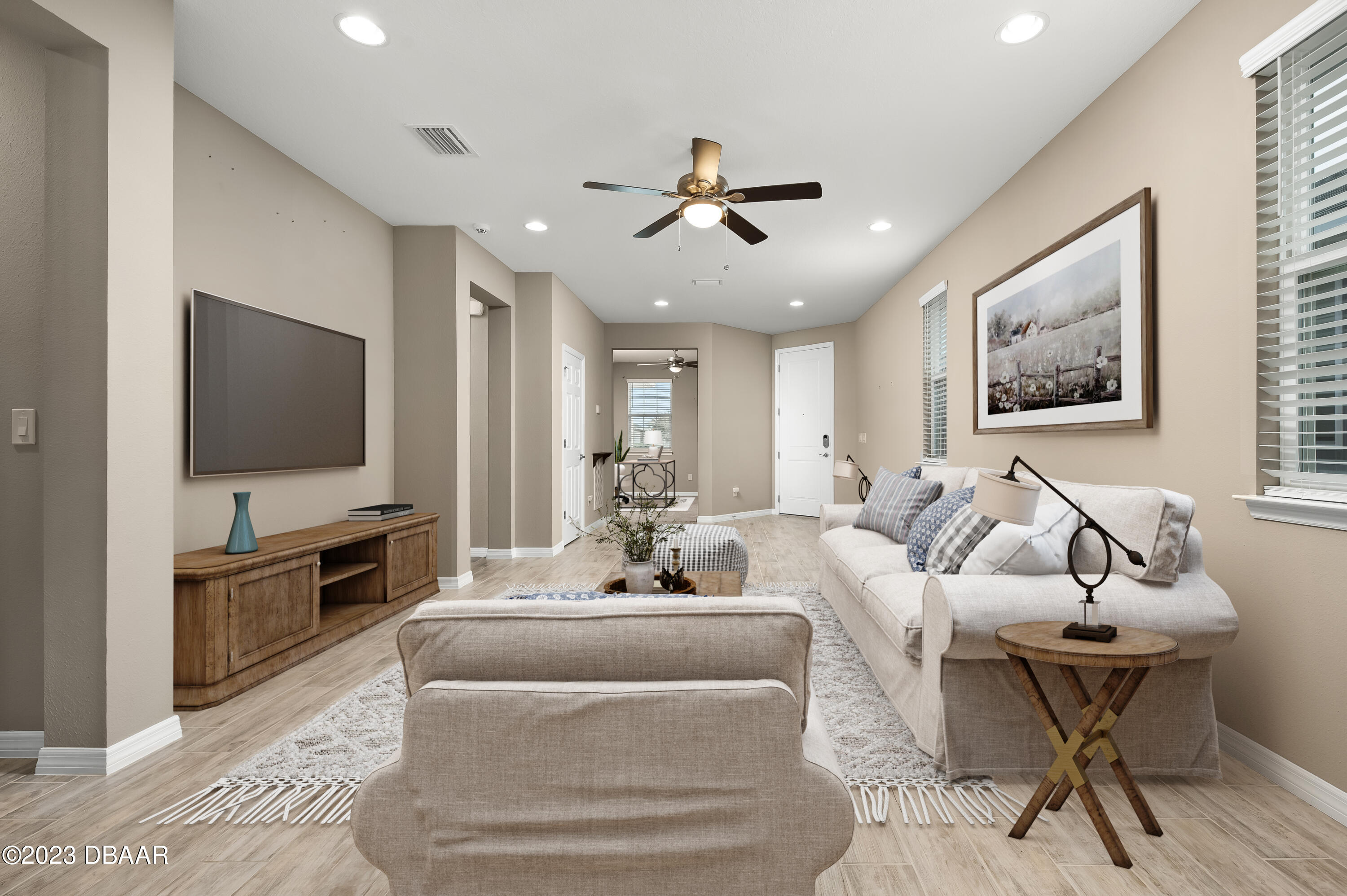 5658 Northwest 40th Loop Ocala, FL 34482 - Photo 17 of 80 a living room with furniture and a flat screen tv