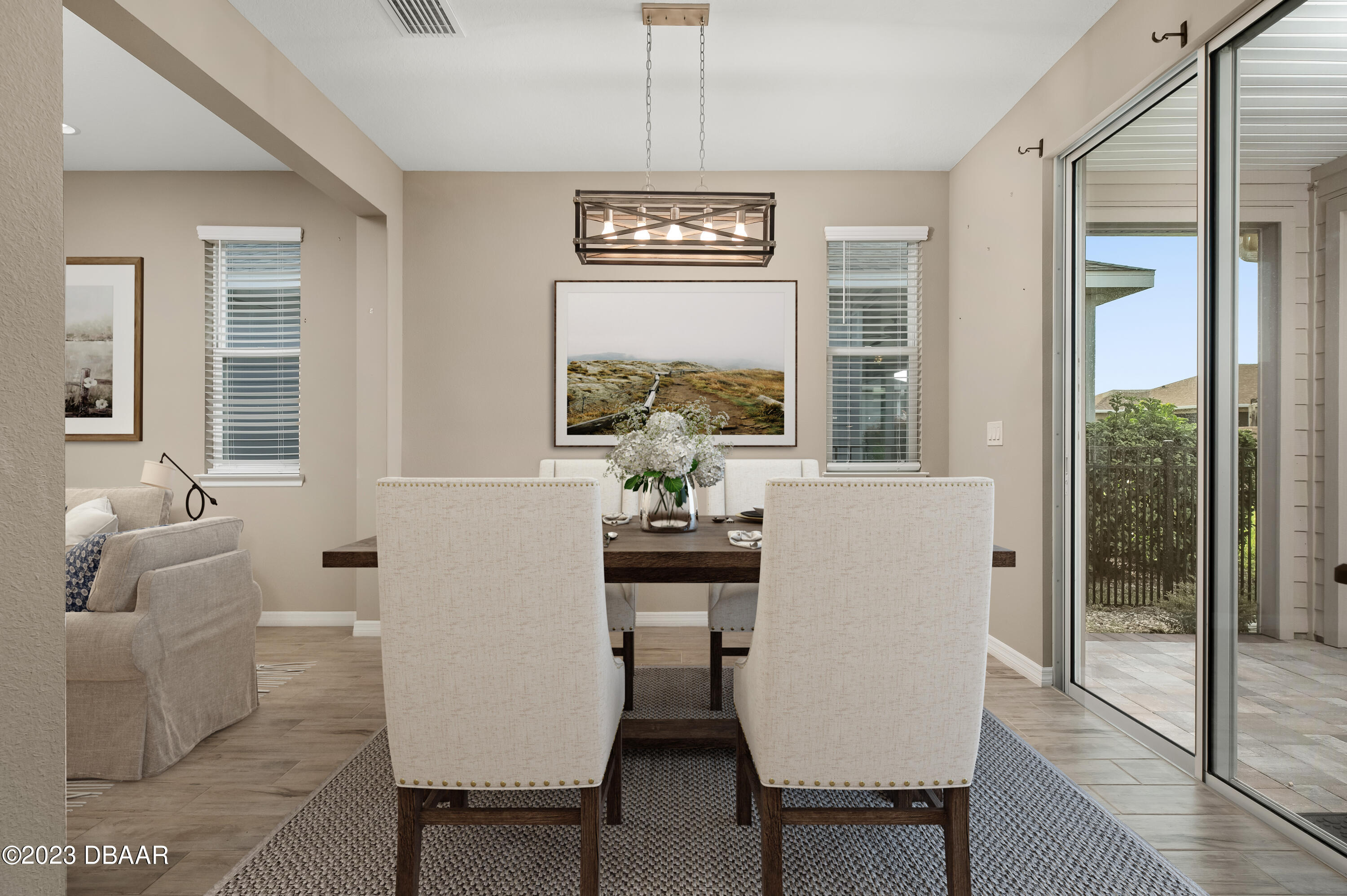 5658 Northwest 40th Loop Ocala, FL 34482 - Photo 19 of 80 a view of a dining room with furniture large windows and wooden floor