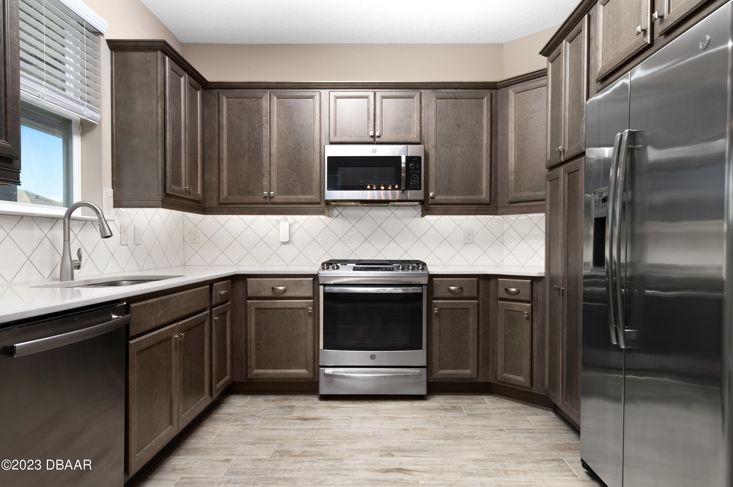 5658 Northwest 40th Loop Ocala, FL 34482 - Photo 23 of 80 a kitchen with stainless steel appliances granite countertop a refrigerator and a sink