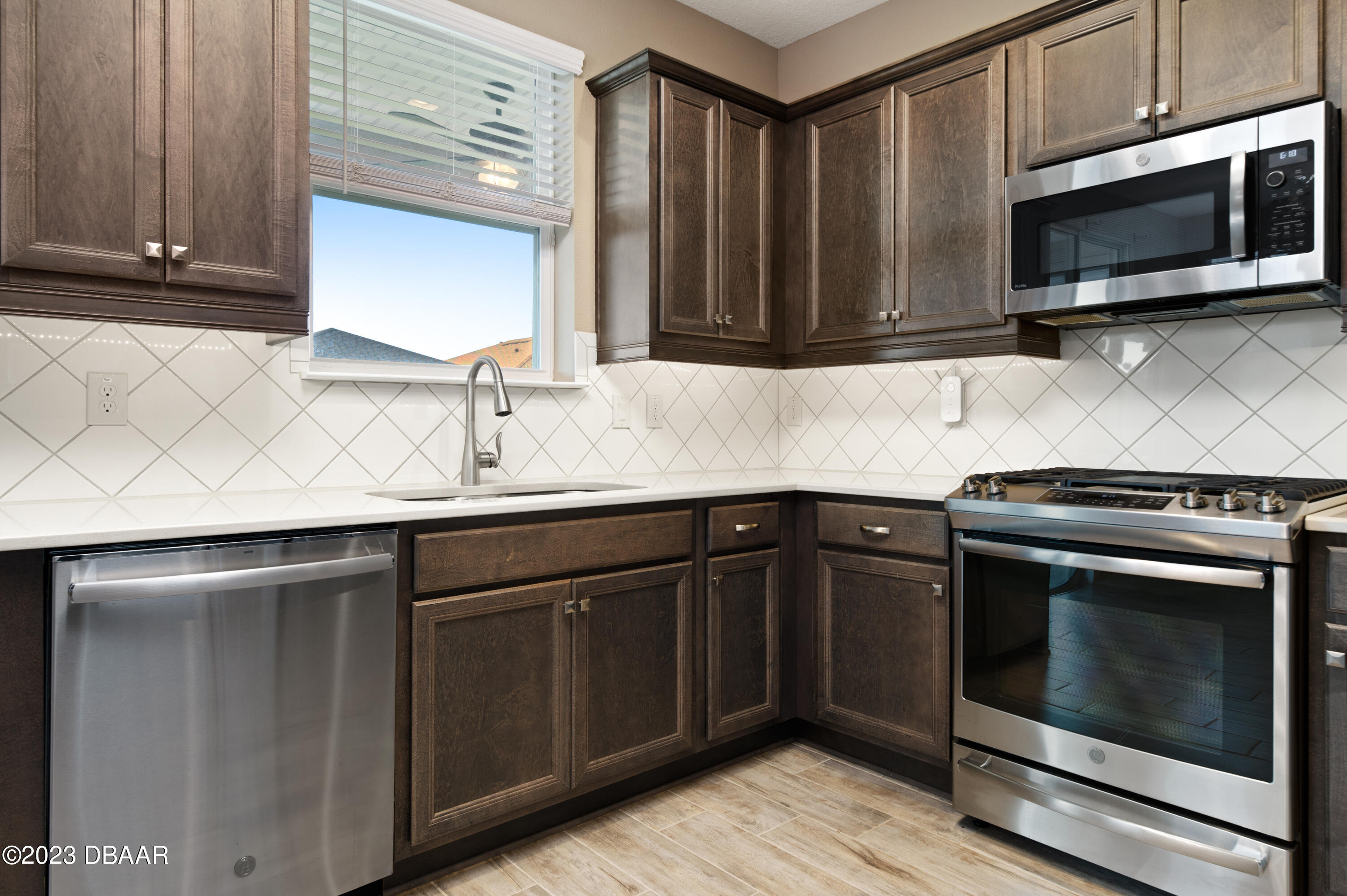 5658 Northwest 40th Loop Ocala, FL 34482 - Photo 24 of 80 a kitchen with granite countertop cabinets stainless steel appliances and wooden cabinets