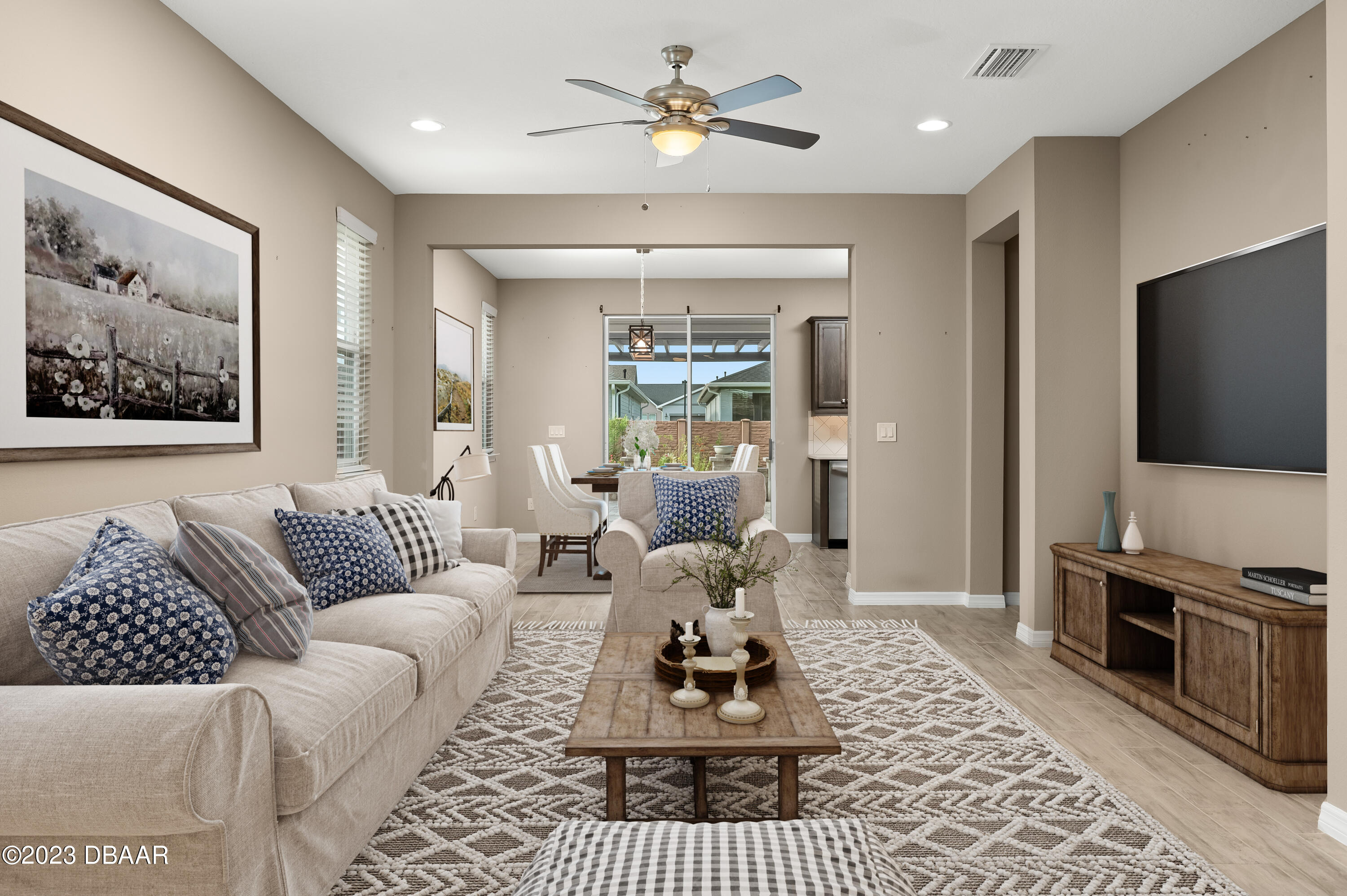 5658 Northwest 40th Loop Ocala, FL 34482 - Photo 26 of 80 a living room with furniture a flat screen tv and a chandelier
