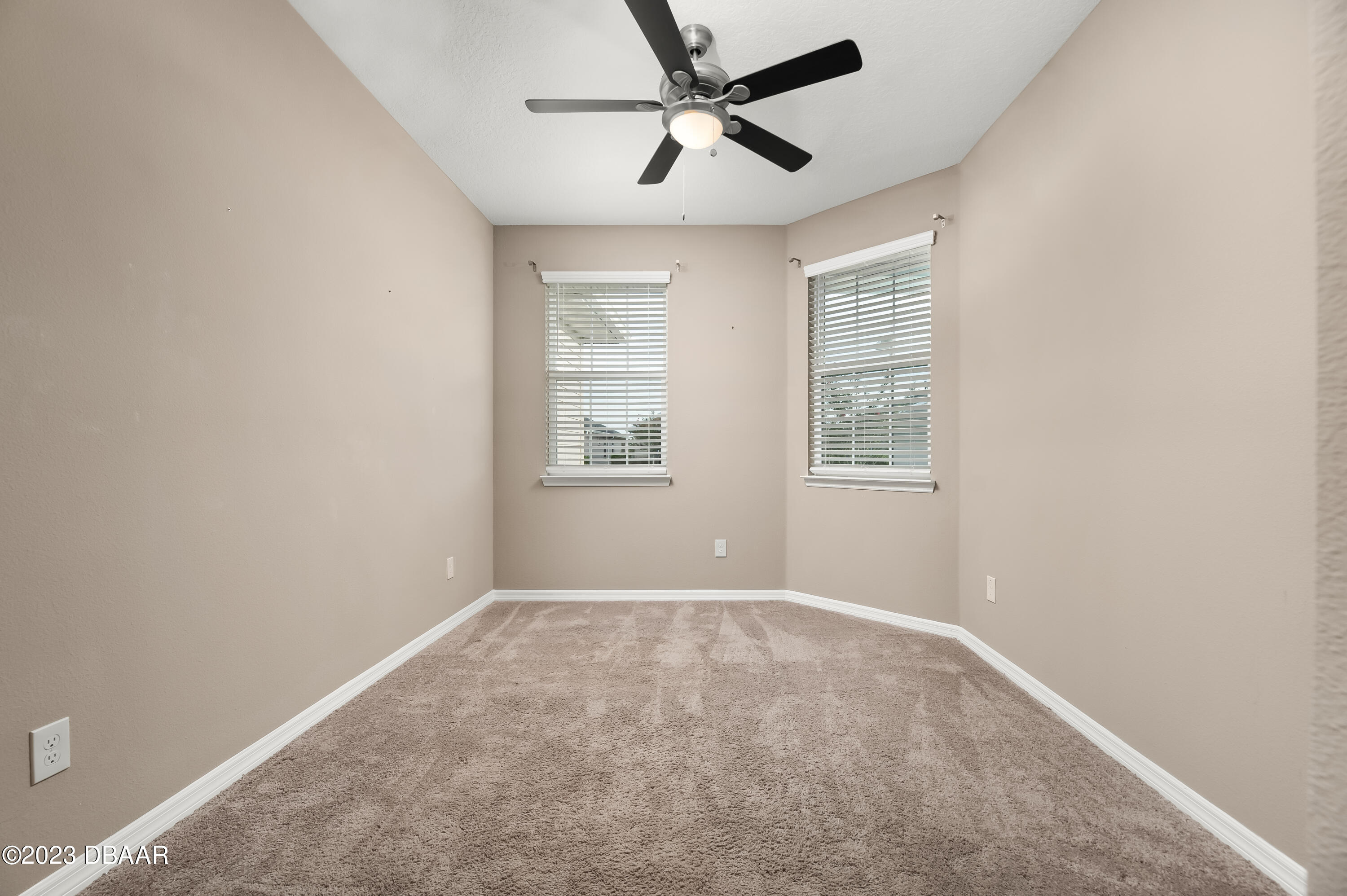 5658 Northwest 40th Loop Ocala, FL 34482 - Photo 31 of 80 an empty room with windows and fan