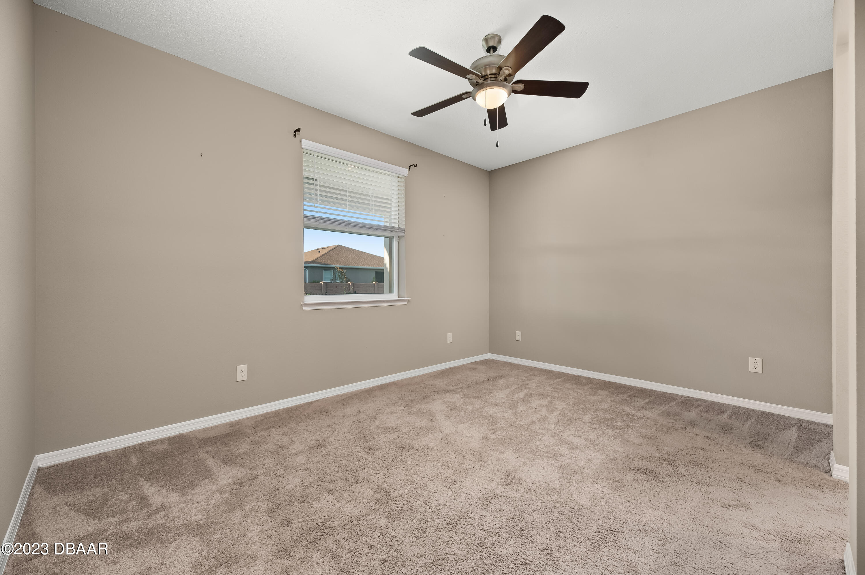 5658 Northwest 40th Loop Ocala, FL 34482 - Photo 35 of 80 an empty room with a ceiling fan and a window