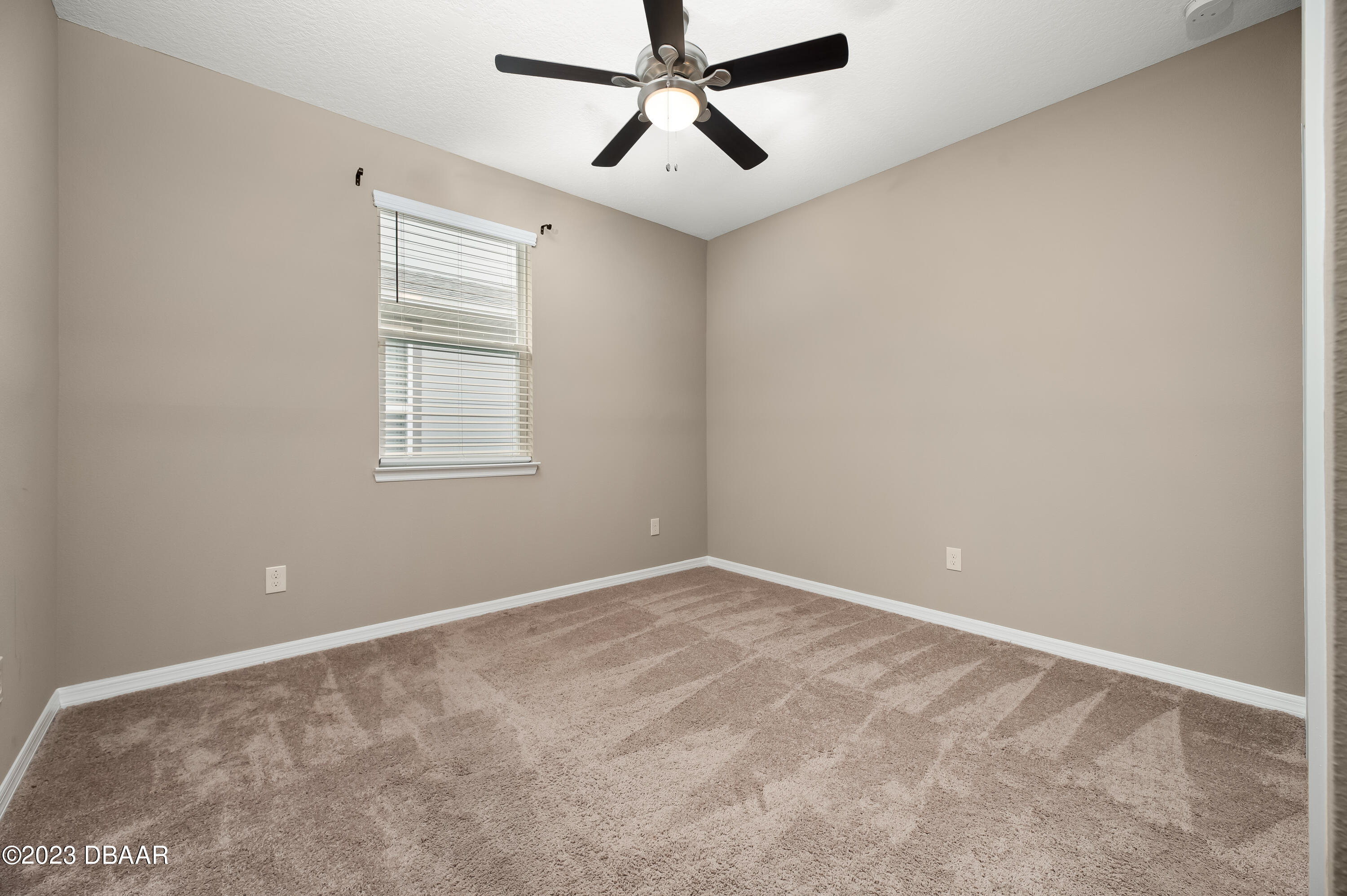 5658 Northwest 40th Loop Ocala, FL 34482 - Photo 42 of 80 an empty room with windows and fan
