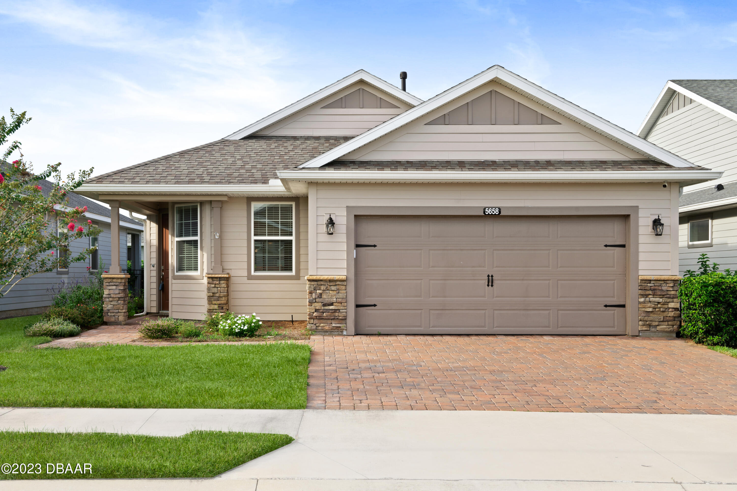 5658 Northwest 40th Loop Ocala, FL 34482 - Photo 51 of 80 a front view of a house with a yard and garage