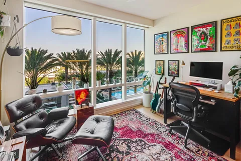 a reading room with furniture and a flat screen tv
