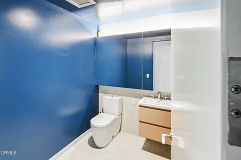 a white toilet sitting next to a bathroom sink