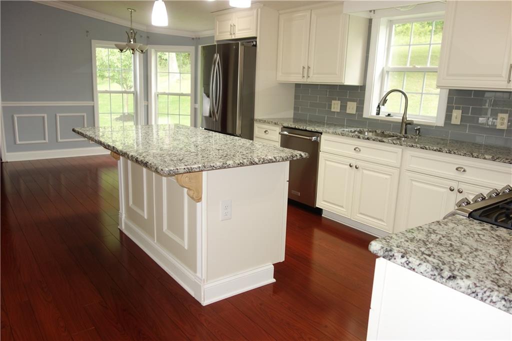 1230 Mounts Road Washington, PA 15301 - Photo 8 of 34 a kitchen with stainless steel appliances granite countertop a stove a sink dishwasher and a refrigerator with wooden floor
