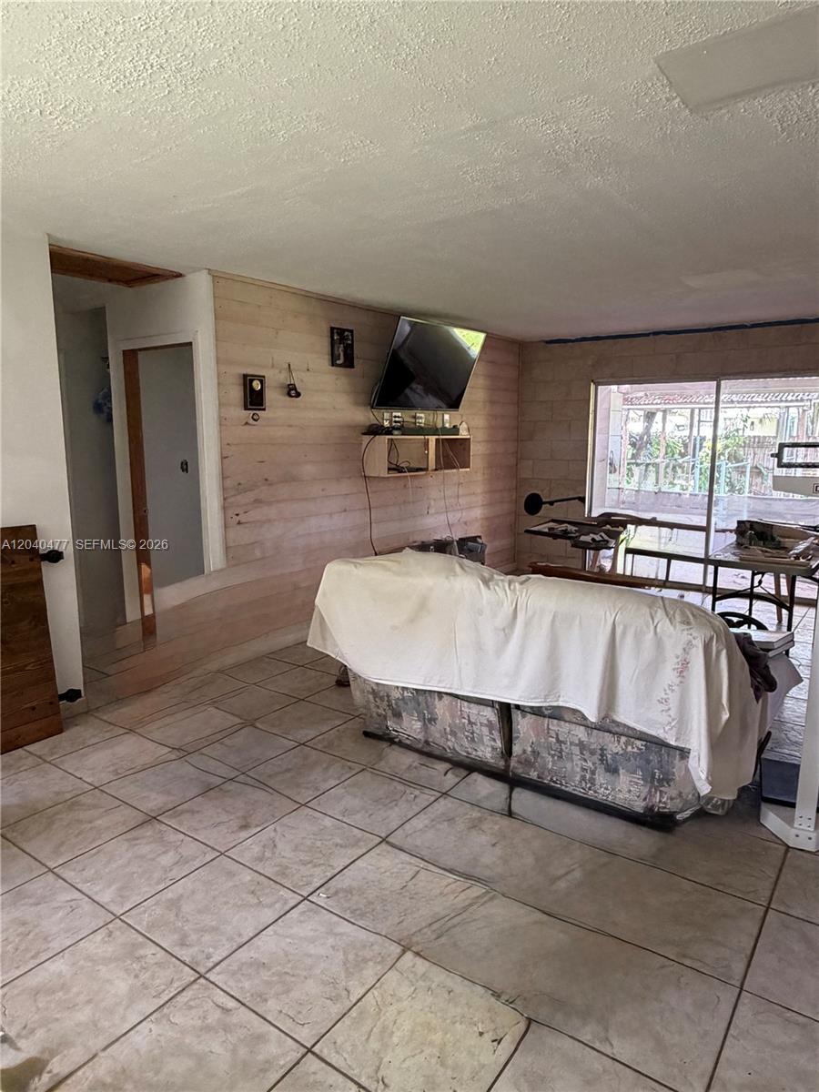 9110 Southwest 44th Street Miami, FL 33165 - Photo 7 of 18 a spacious bedroom with a bed and window