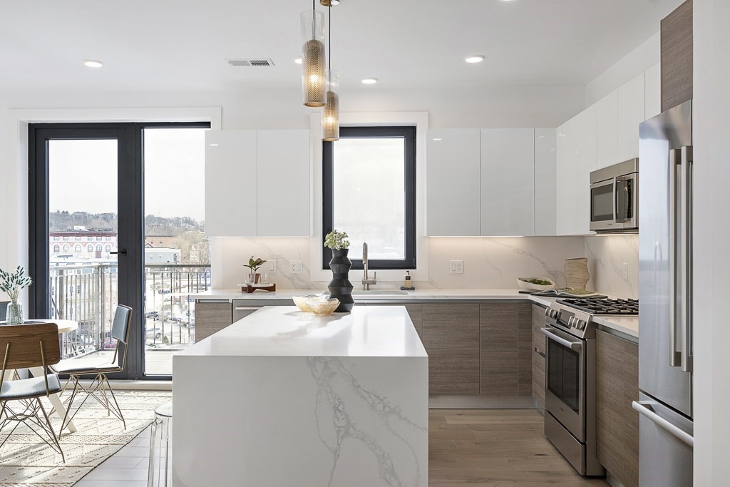 30 Penniman Road, Unit 307 Boston, MA 02134 - Photo 3 of 10 a kitchen with a sink stove and refrigerator