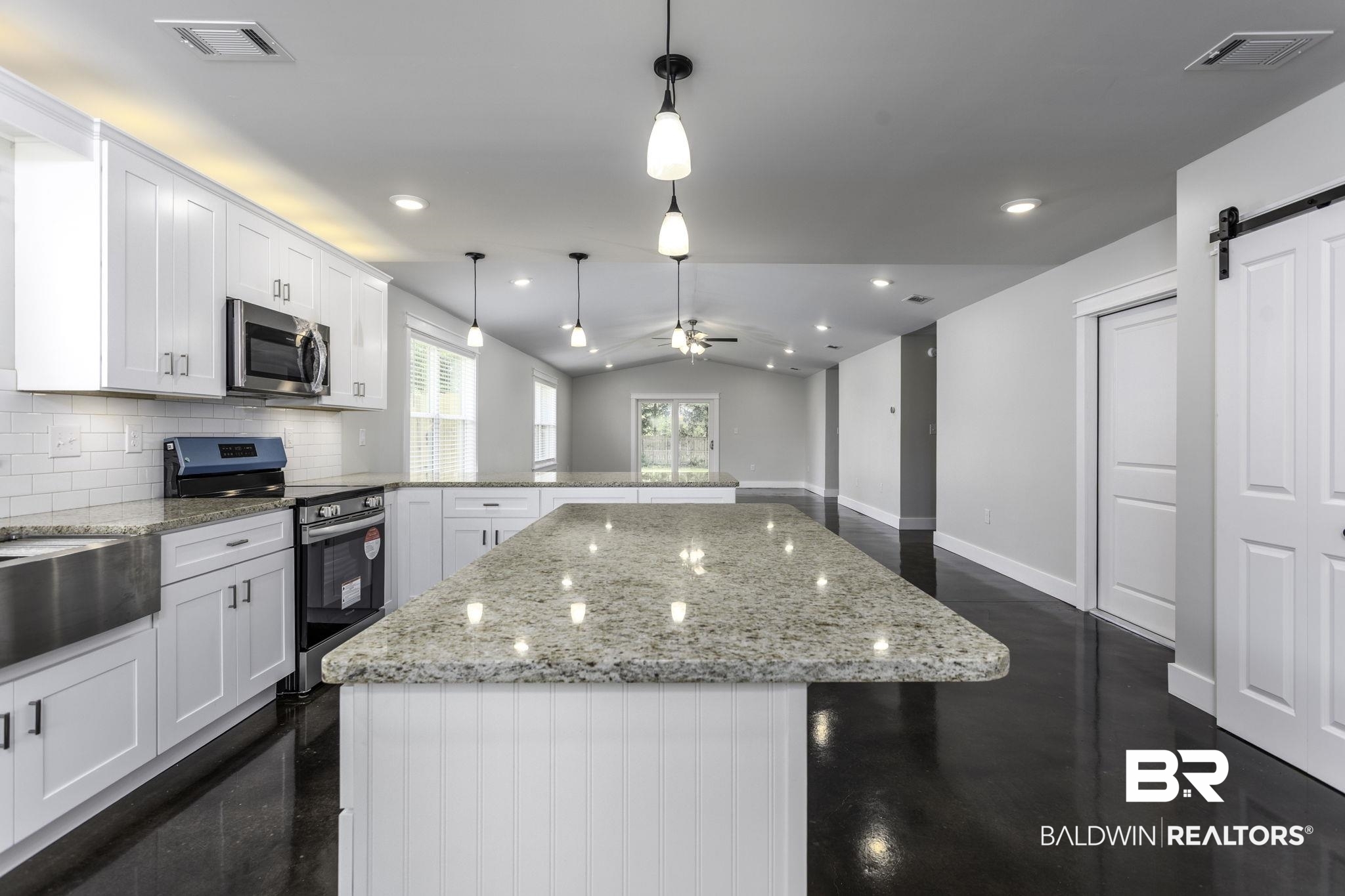 17126 Sugar Loop Foley, AL 36535 - Photo 2 of 28 Kitchen with stainless steel appliances, a peninsula, white cabinets, a kitchen island, and a ceiling fan