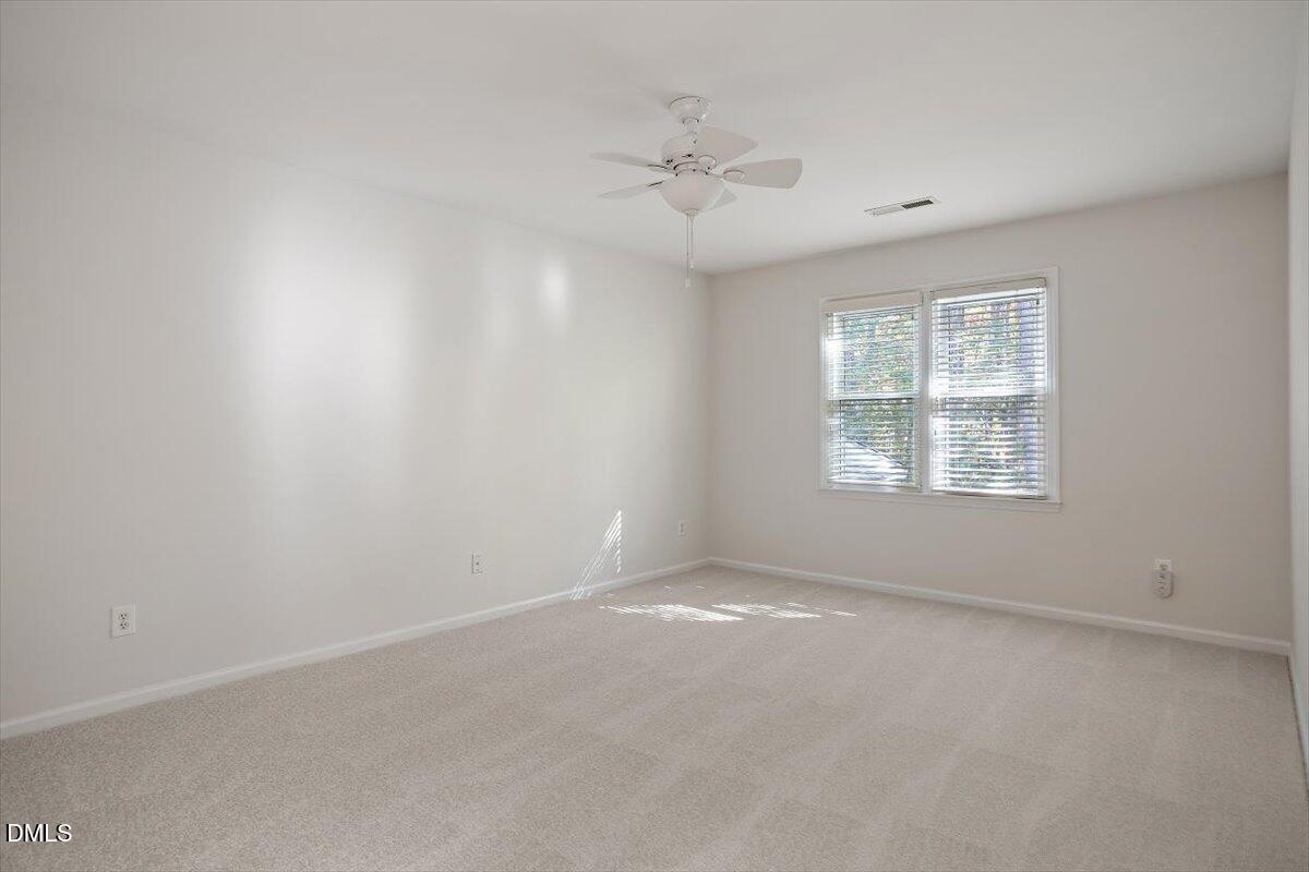 117 Colchis Court Cary, NC 27513 - Photo 29 of 39 an empty room with a window and a ceiling fan