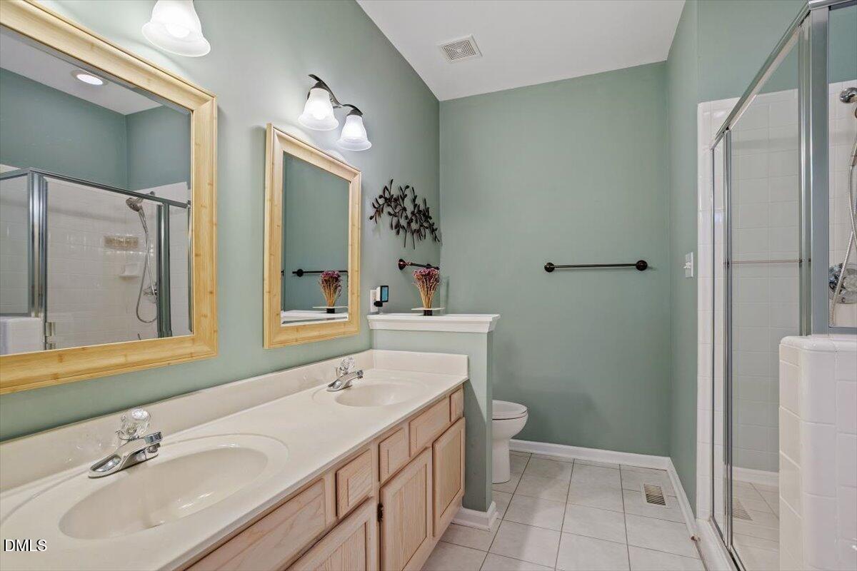 117 Colchis Court Cary, NC 27513 - Photo 6 of 39 a bathroom with a sink a toilet and a mirror