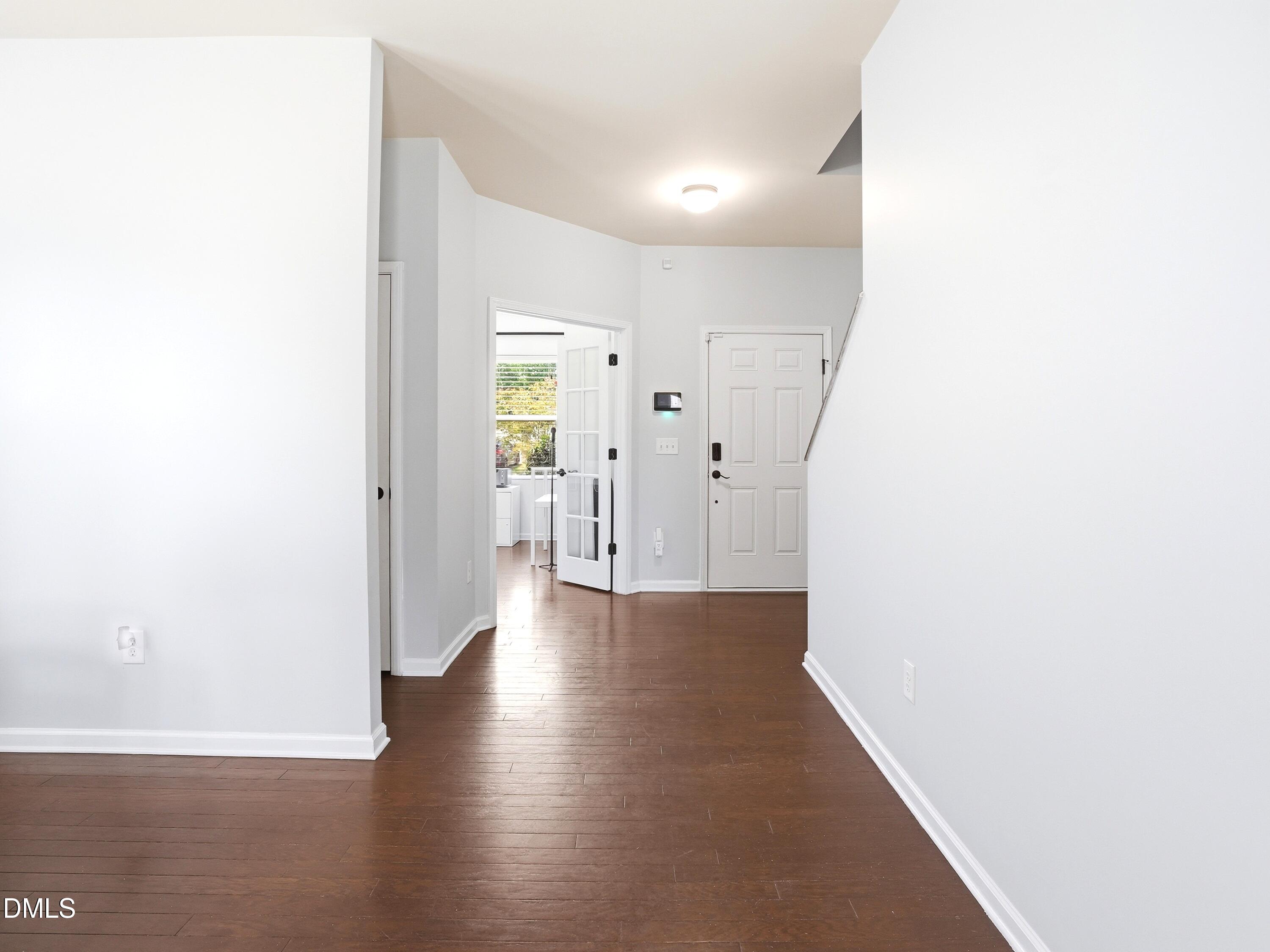 8128 Hovingham Way Raleigh, NC 27616 - Photo 14 of 40 a view of a hallway with wooden floor