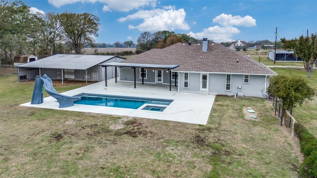 155 Smith Lane Combine, TX 75159 - Photo 23 of 31 Back of property featuring a patio, a yard, and roof with shingles