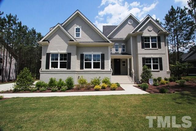 1221 Harrison Ridge Road Wake Forest, NC 27587 - Photo 1 of 25 a front view of a house with a garden and porch