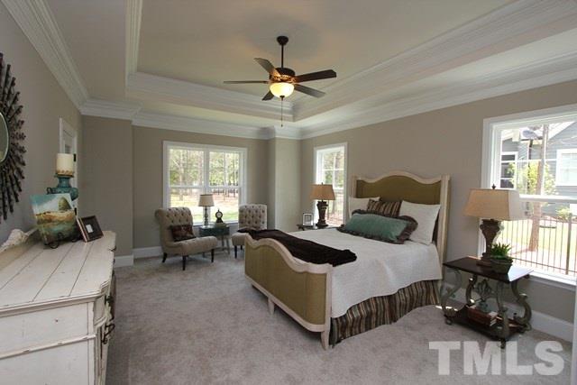 1221 Harrison Ridge Road Wake Forest, NC 27587 - Photo 11 of 25 a spacious bedroom with a bed a couch and window