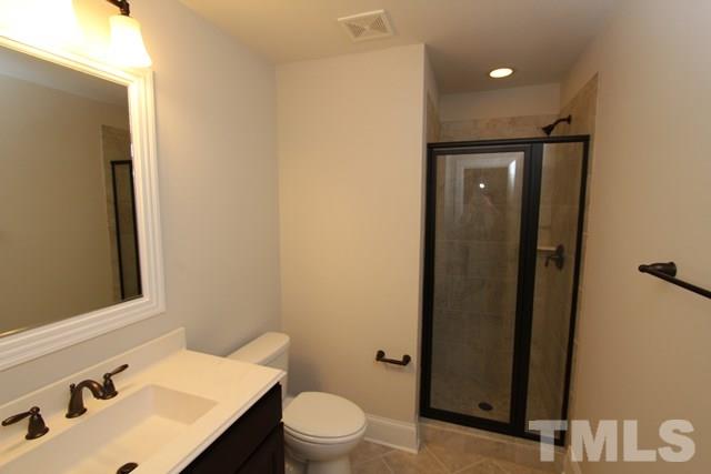 1221 Harrison Ridge Road Wake Forest, NC 27587 - Photo 20 of 25 a bathroom with a sink a toilet and shower