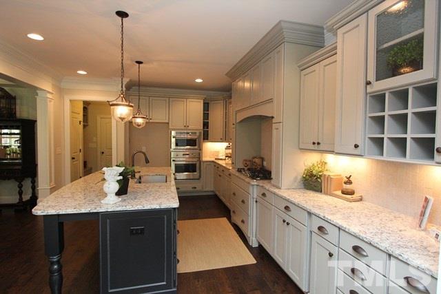 1221 Harrison Ridge Road Wake Forest, NC 27587 - Photo 7 of 25 a large kitchen with sink a counter space appliances and cabinets