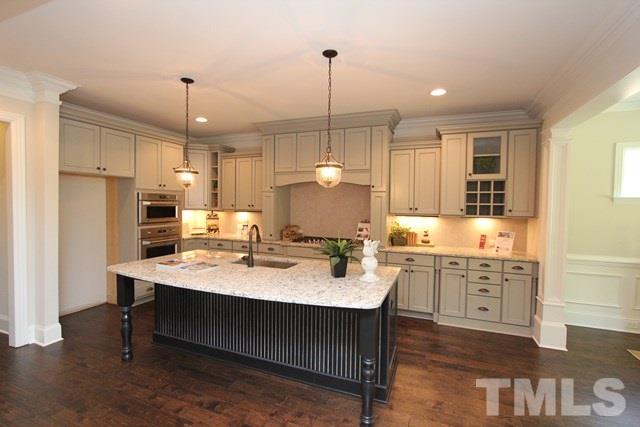 1221 Harrison Ridge Road Wake Forest, NC 27587 - Photo 9 of 25 a kitchen with a sink stove and refrigerator