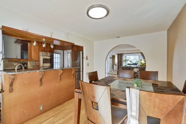 a view of a livingroom with furniture wooden floor and windows