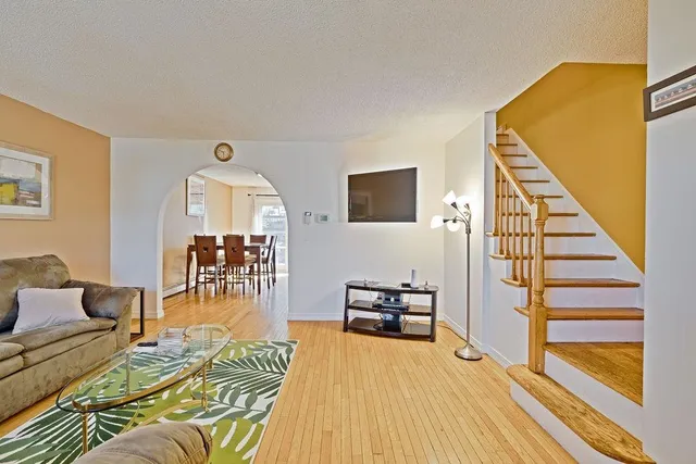 a living room with furniture and a wooden floor