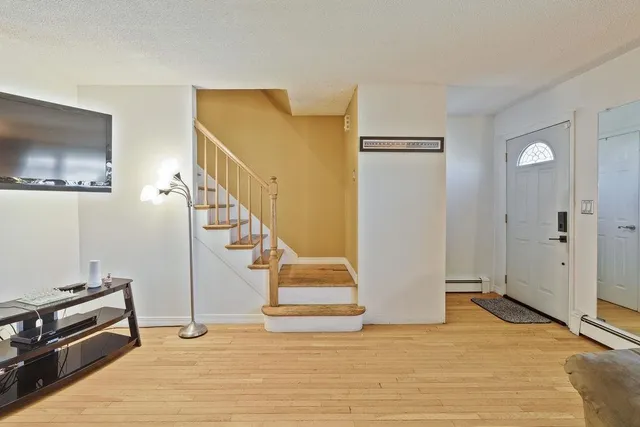 a view of an entryway with wooden floor