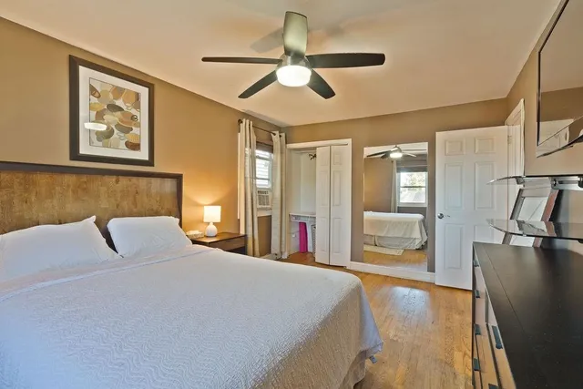 a bedroom with a large bed and a chandelier