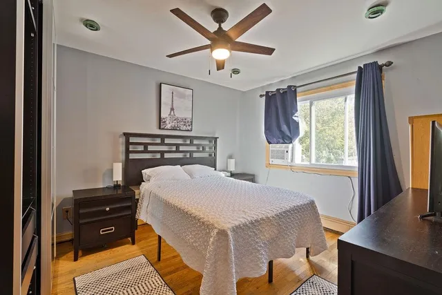 a bedroom with a bed and a desk