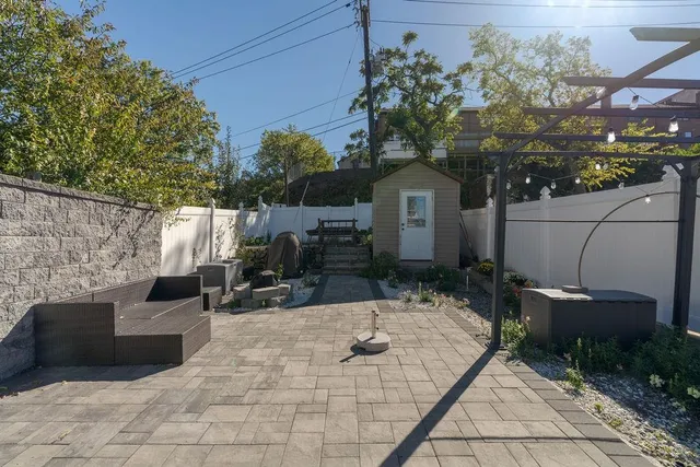 a view of couches and a fire pit in the patio in front of house