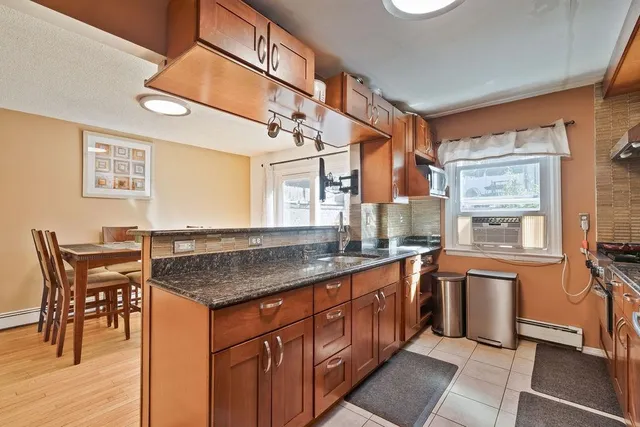 a kitchen with stainless steel appliances granite countertop a sink and cabinets