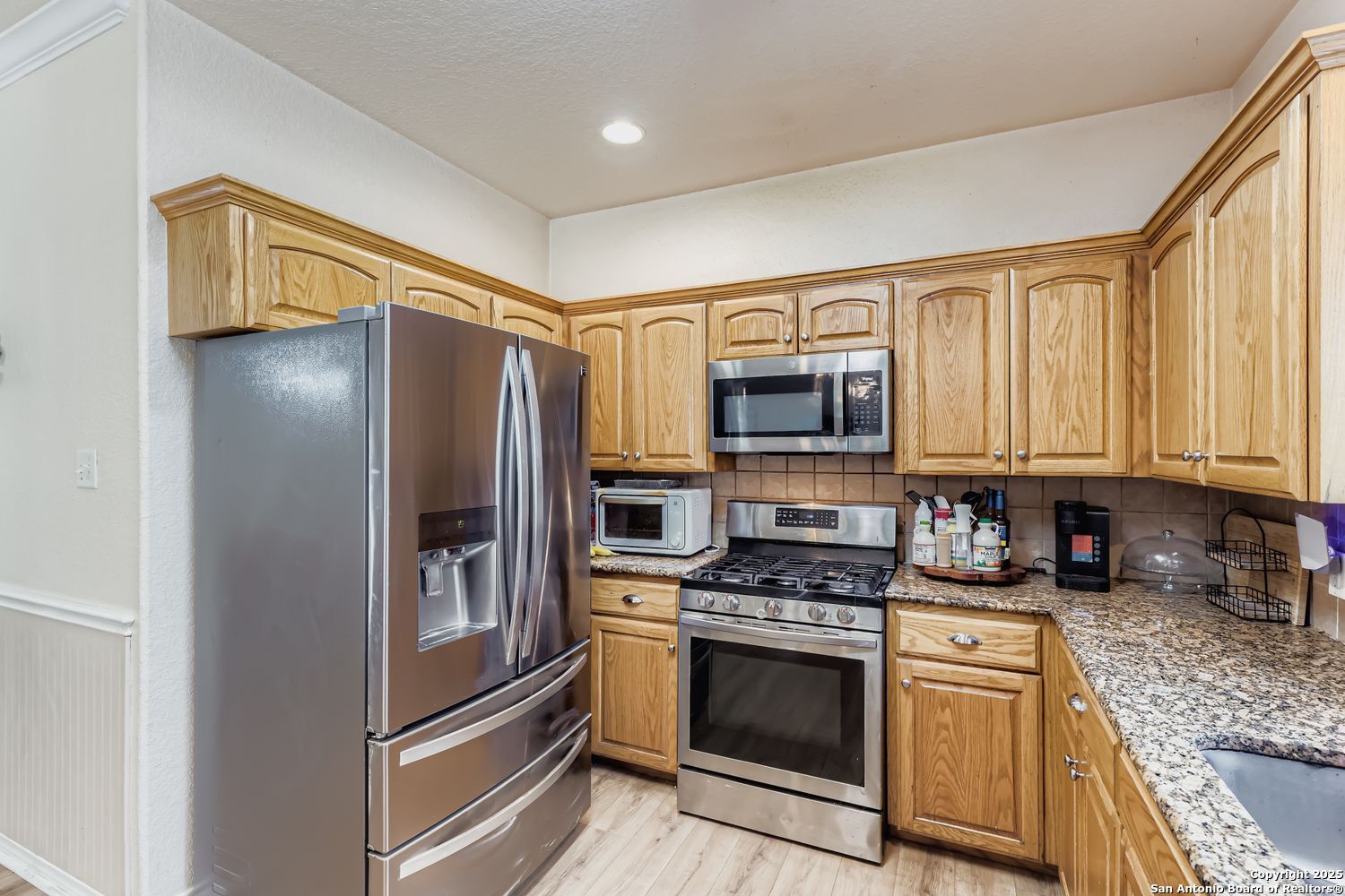 118 Santa Fe Seguin, TX 78155 - Photo 11 of 44 a kitchen with stainless steel appliances granite countertop a refrigerator stove and sink