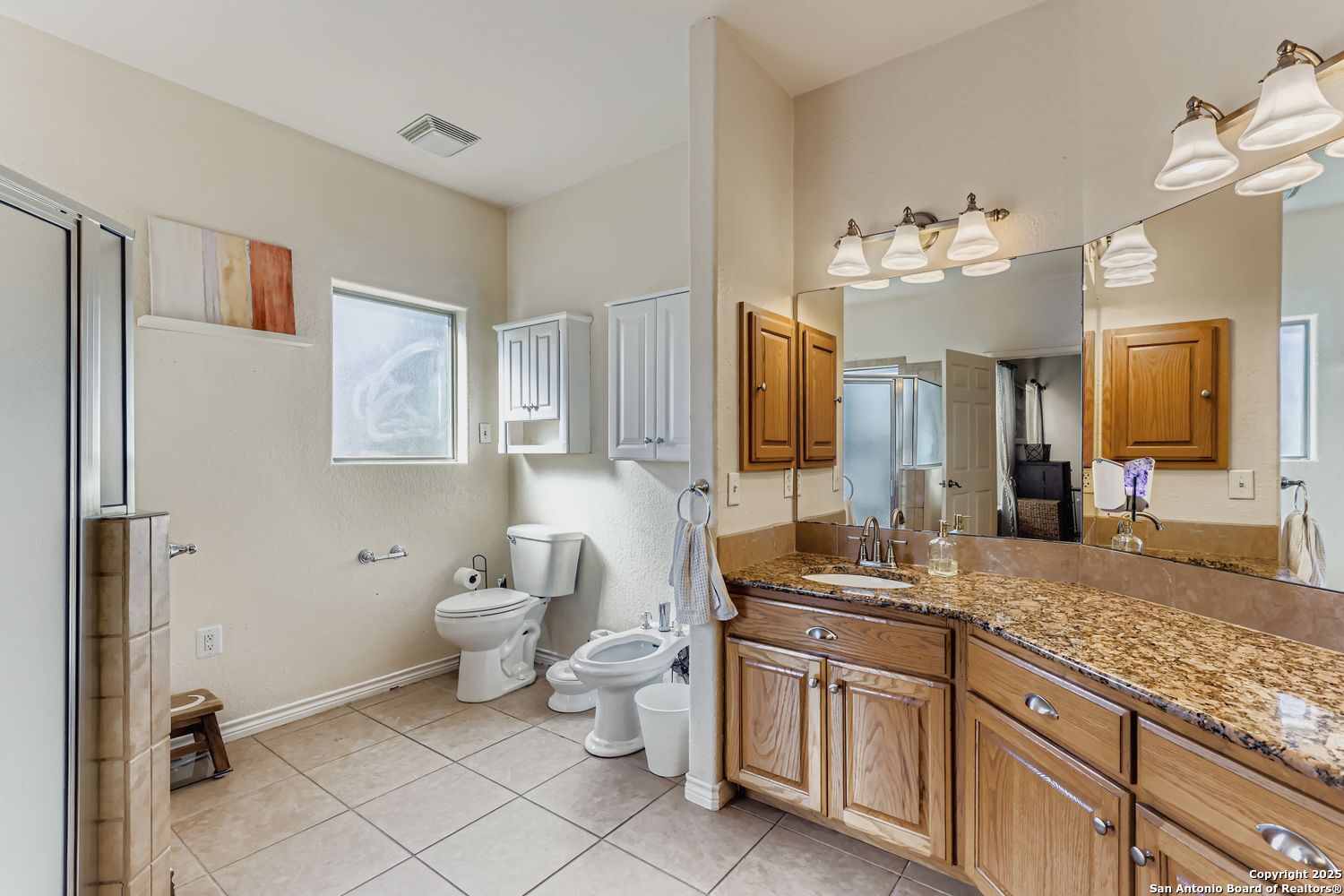 118 Santa Fe Seguin, TX 78155 - Photo 16 of 44 a spacious bathroom with a granite countertop sink mirror and toilet