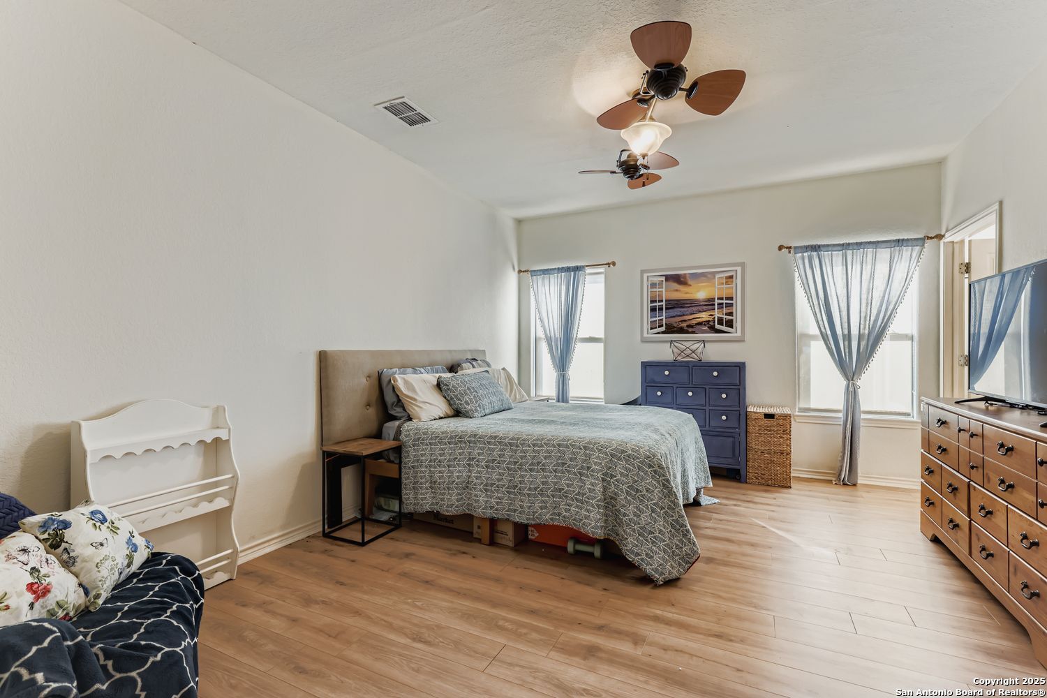 118 Santa Fe Seguin, TX 78155 - Photo 28 of 44 a bedroom with a bed and wooden floor