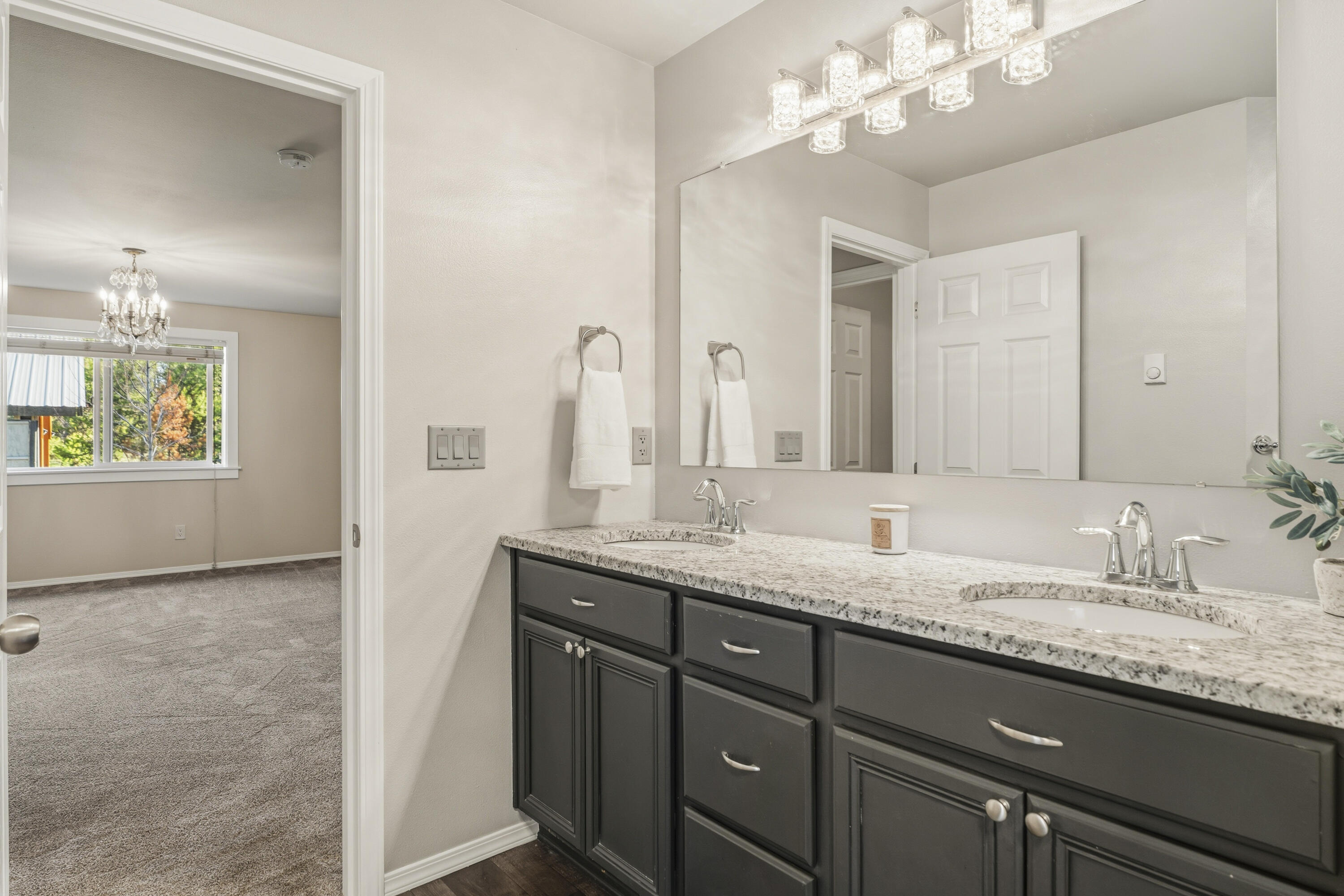 16050 Dick Road La Pine, OR 97739 - Photo 28 of 59 a bathroom with a granite countertop double vanity sink and a mirror