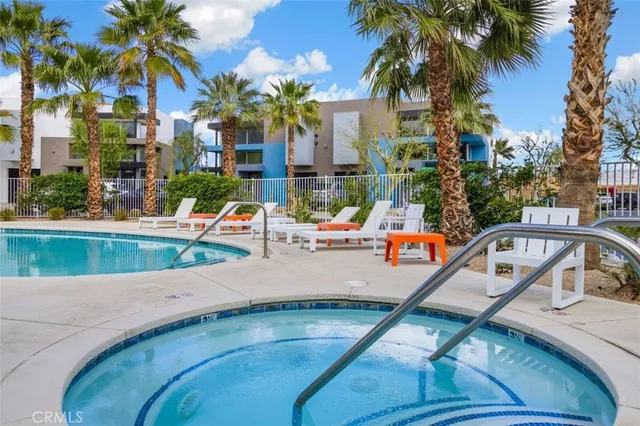 a view of swimming pool with outdoor seating and plants