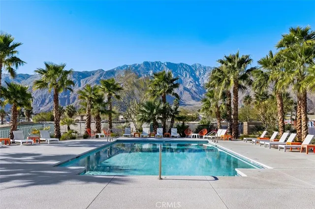 a view of a patio with a table and chairs under an umbrella