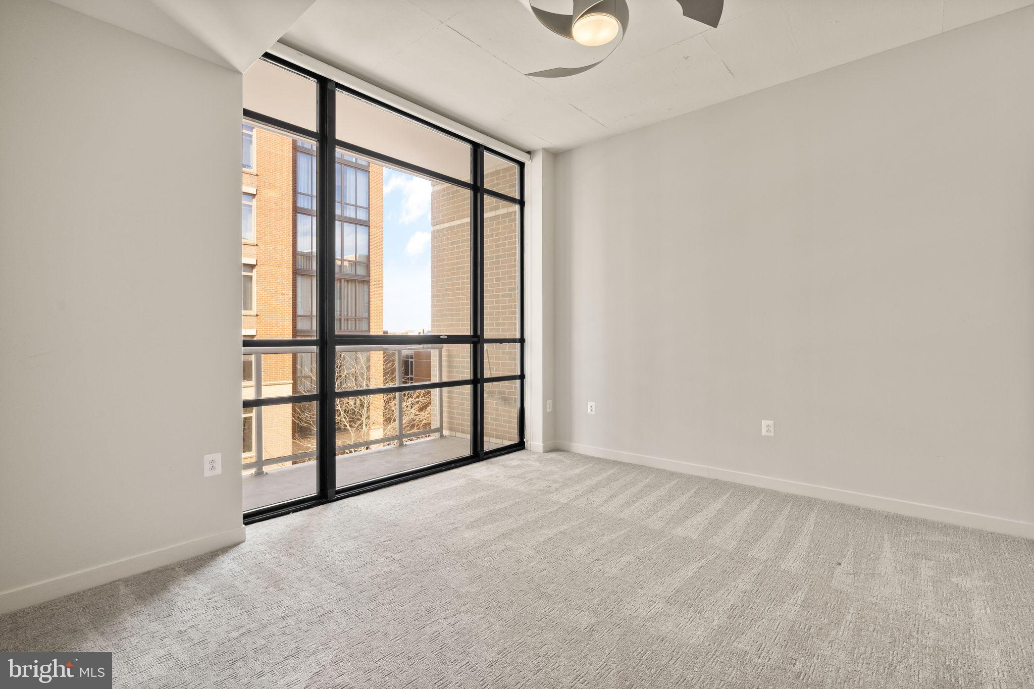 12025 New Dominion Parkway, Unit 406 Reston, VA 20190 - Photo 20 of 31 an empty room with windows with walls