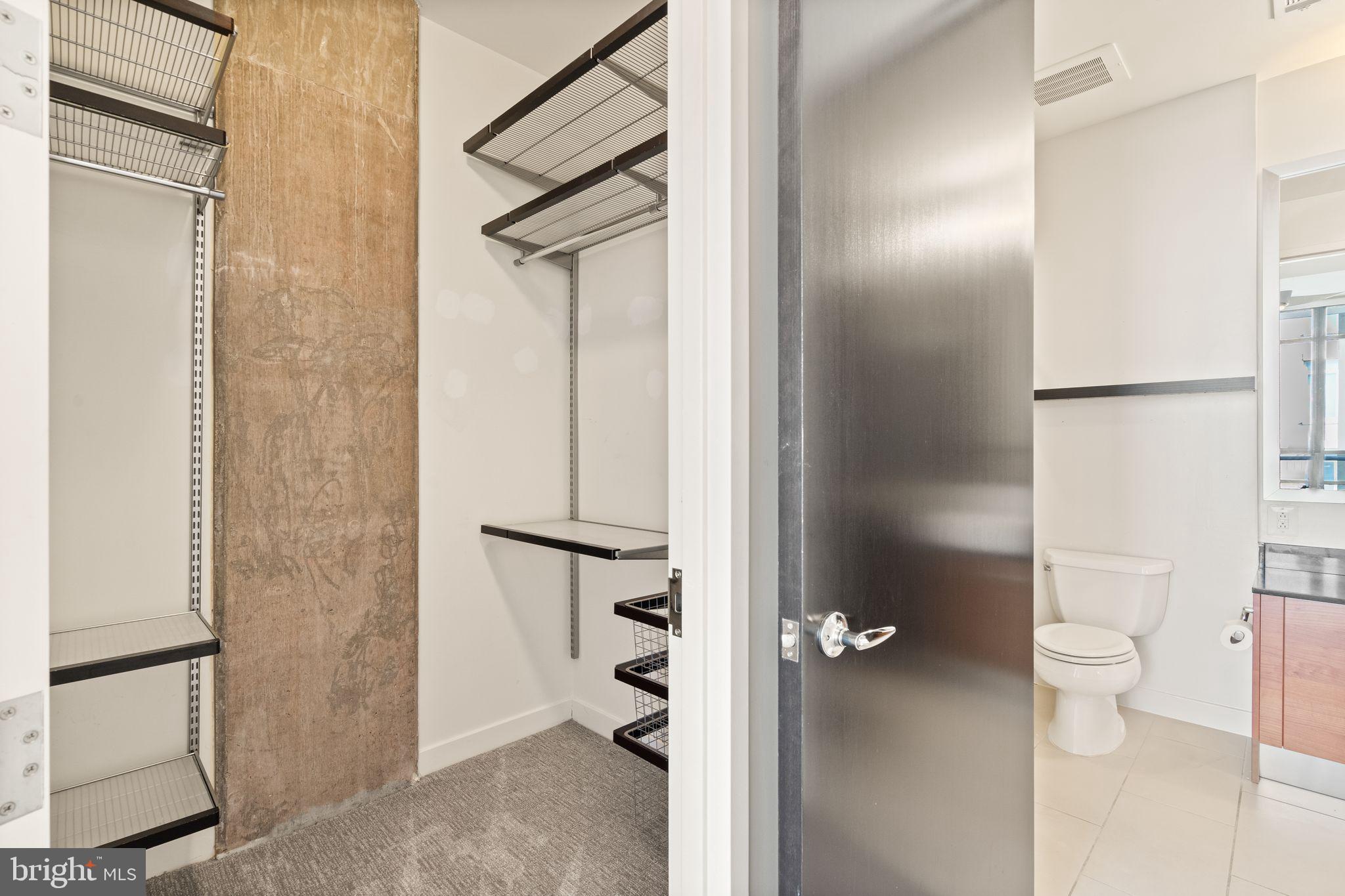 12025 New Dominion Parkway, Unit 406 Reston, VA 20190 - Photo 24 of 31 a bathroom with a granite countertop shower a toilet and a sink