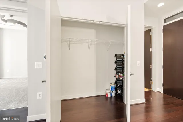 a view of a hallway with wooden floor and entryway
