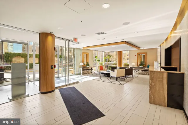 a living room with patio furniture and a chandelier