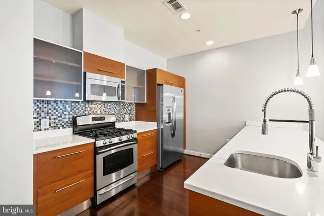 a kitchen with granite countertop a stove and a sink