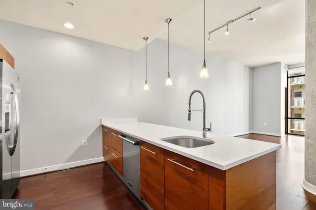 a kitchen with a sink and a wooden floor