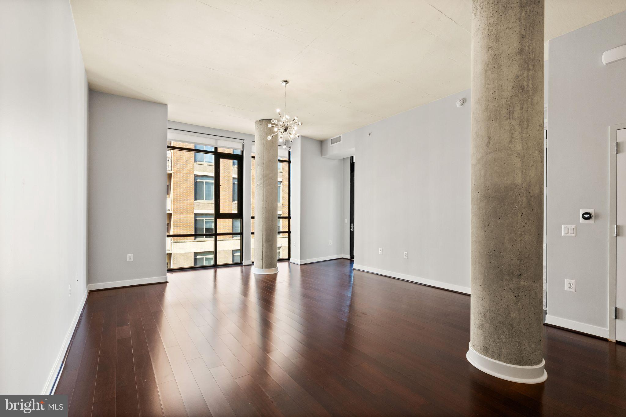 12025 New Dominion Parkway, Unit 406 Reston, VA 20190 - Photo 10 of 31 a view of an empty room with wooden floor and a window