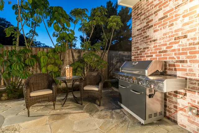 a view of a backyard with chairs