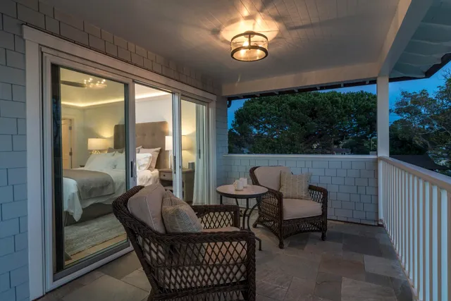a view of a porch with furniture and wooden floor